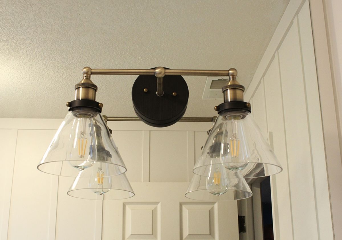 Brass lighting for mirror in bathroom