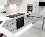 Household appliances in a white kitchen in high-tech style – Microwave, stove, oven, TV