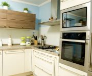 Kitchen High-Tech Style – Wooden facades of light shades soften this strict style