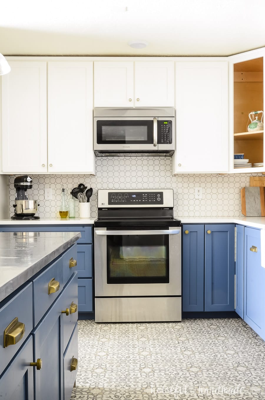 Kitchen remodel showing DIY routed cabinet doors. Blue lower cabinets and white upper cabinets. 