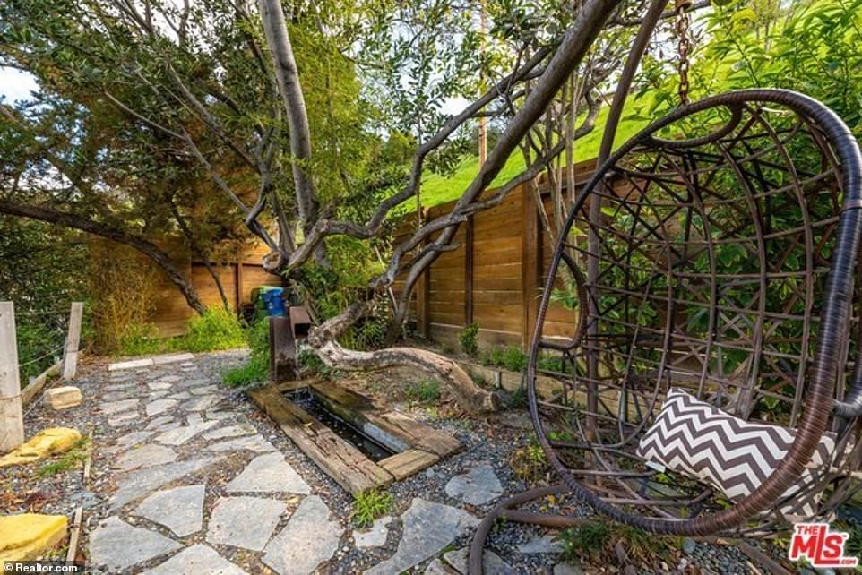 There is a stunning zen garden, comfortable lounge areas, a fountain and a hanging basket chair in the back of the property