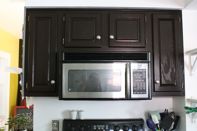 Refinished kitchen cabinets make appliances blend right in.