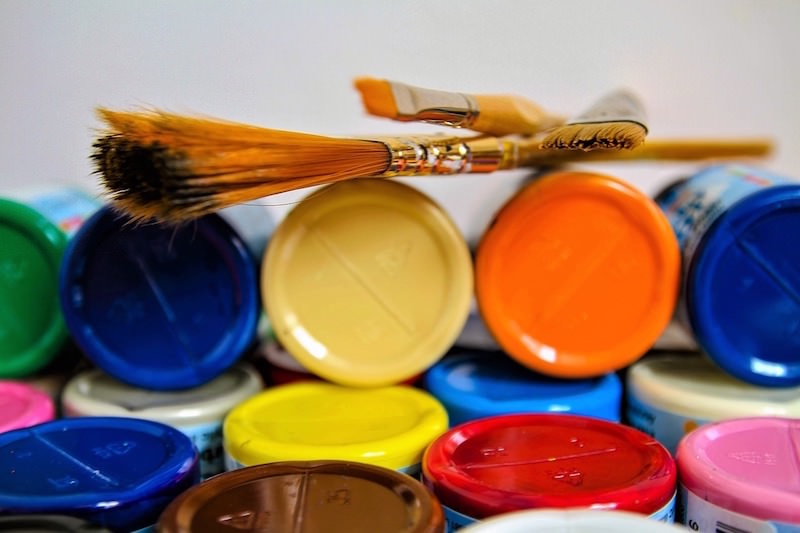 Brushes on top of craft paint bottles
