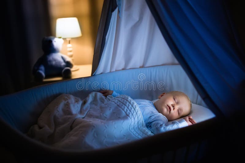 Baby boy sleeping at night royalty free stock image