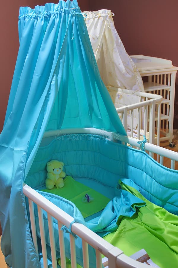 Blue baby cot stock photos