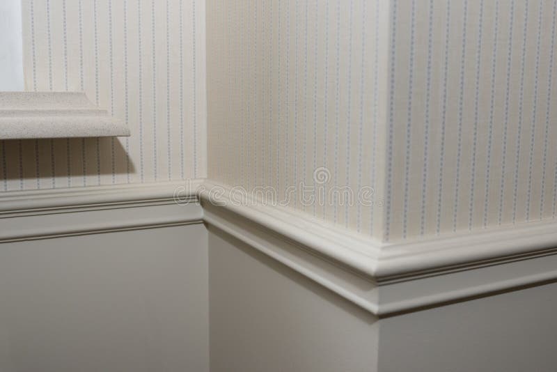 Ceiling moldings in the interior, detail of a angular wall skirting.  stock images