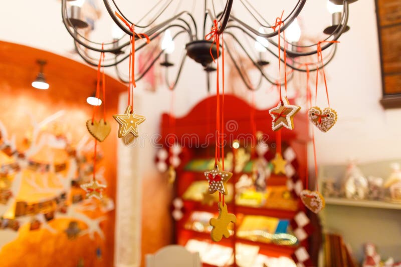 The close-up view of the christmas cookies hanging on the chandelier at the blurred background of the shop. The close-up view of the christmas cookies hanging royalty free stock photos