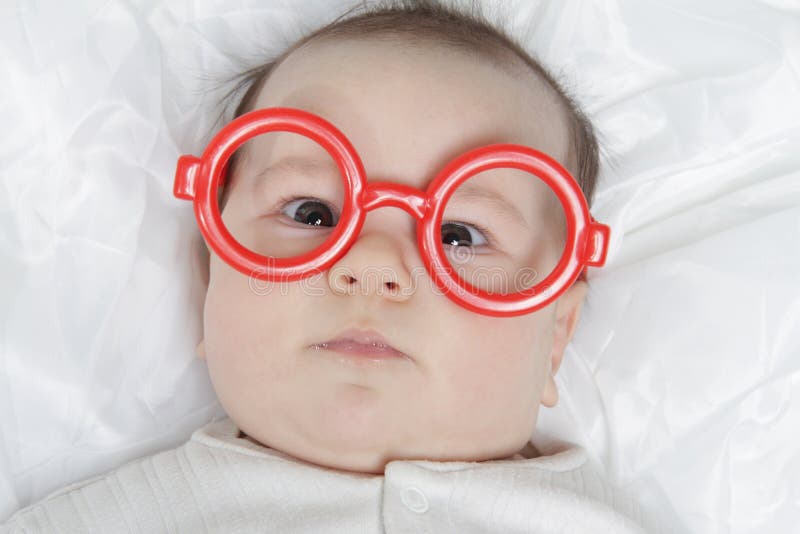 Cute baby in glasses royalty free stock image