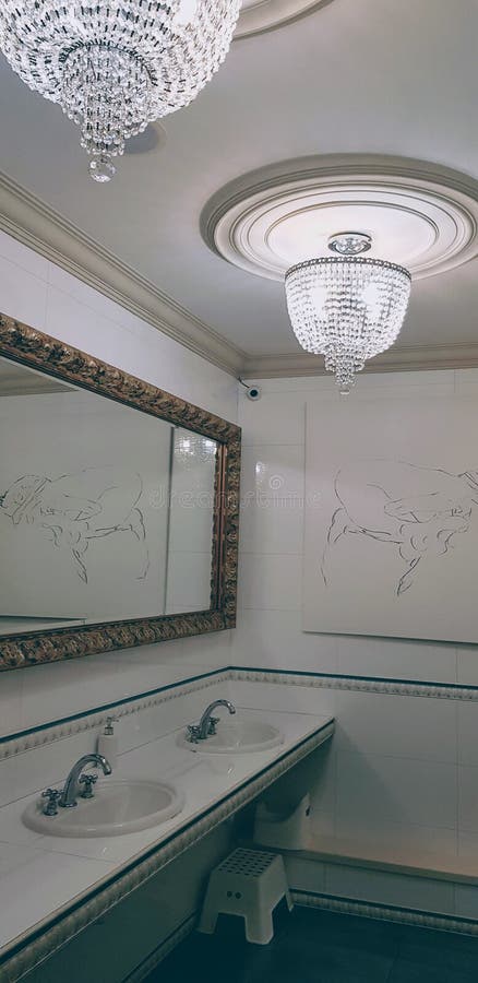 Elegant bathroom with white interior and elegant chandelier royalty free stock images