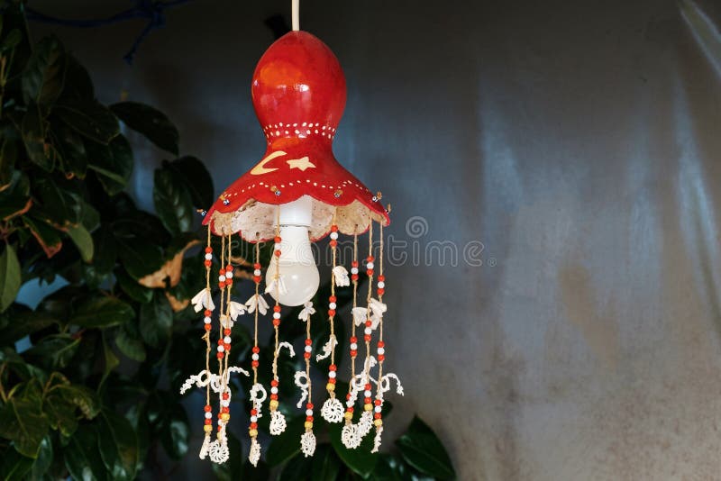Homemade lamp with a bulb in the style of the Turkish flag and colors of the country. Red chandelier on a wire with handmade decorations royalty free stock images