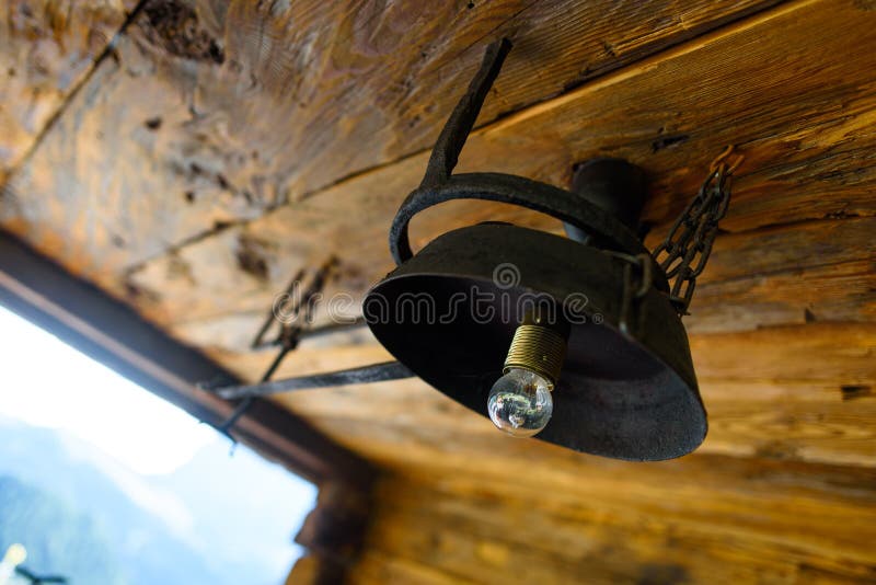Light bulb and chandelier on the ceiling. Old light bulb and self-made chandelier on the ceiling royalty free stock photography