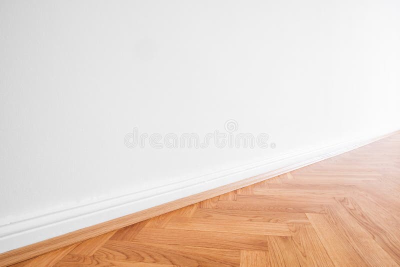 Primed white wall and wooden parquet floor - apartment interior background.  stock photo