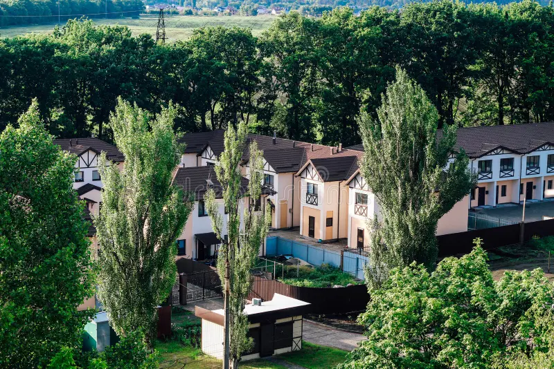 Private residential townhouses. Modern housing in the countryside in green foliage. Ideal family plot. Private residential townhouses. Modern housing in the stock photo