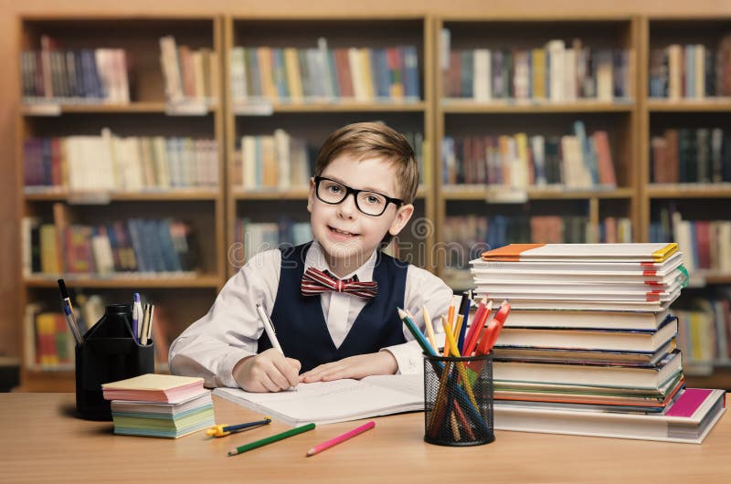 School Kid Studying in Library, Child Writing Book, Shelves stock image