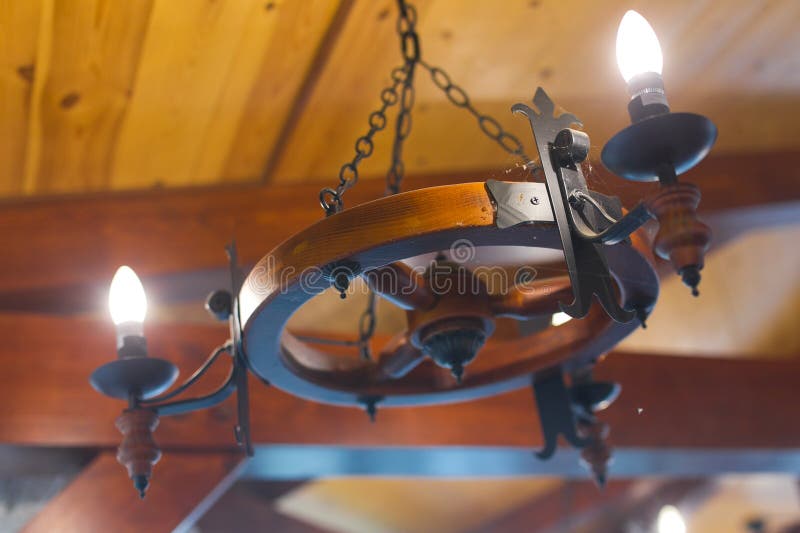 Wagon wheel chandelier. Rustic barn wagon wheel chandelier royalty free stock photography