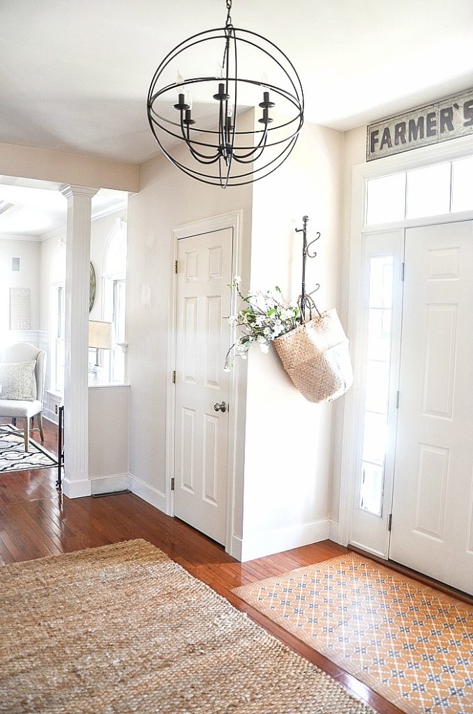 open foyer painted a neutral soft beige with white door